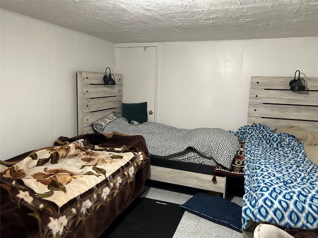 bedroom featuring a decorative wall and tile patterned floors