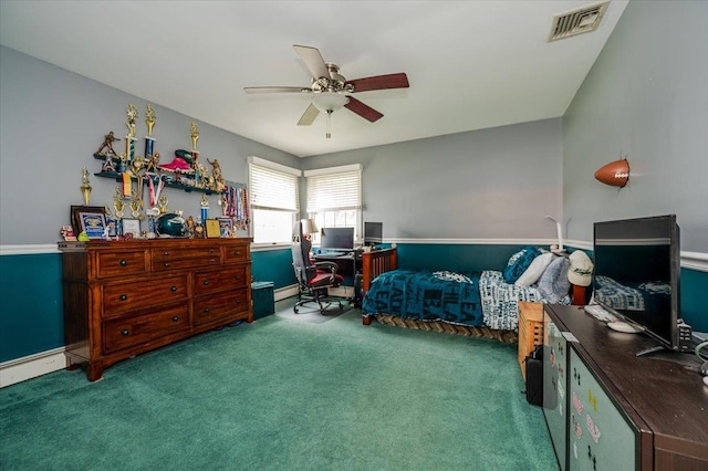 bedroom with a desk, carpet, ceiling fan, a baseboard heating unit, and baseboards