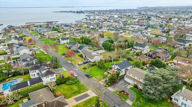 aerial view of property's location featuring nearby suburban area and a nearby body of water