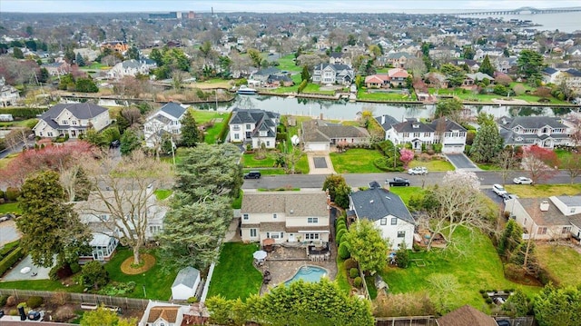 aerial view of property's location with a nearby body of water and nearby suburban area