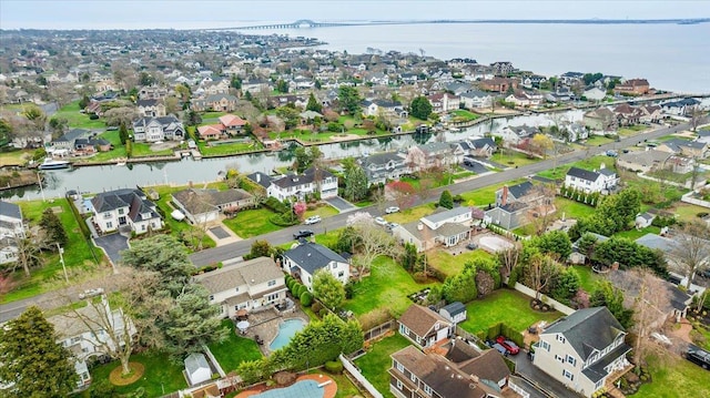 aerial overview of property's location featuring nearby suburban area and a nearby body of water