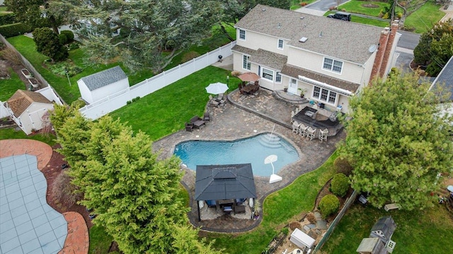 aerial view of property and surrounding area featuring a pool