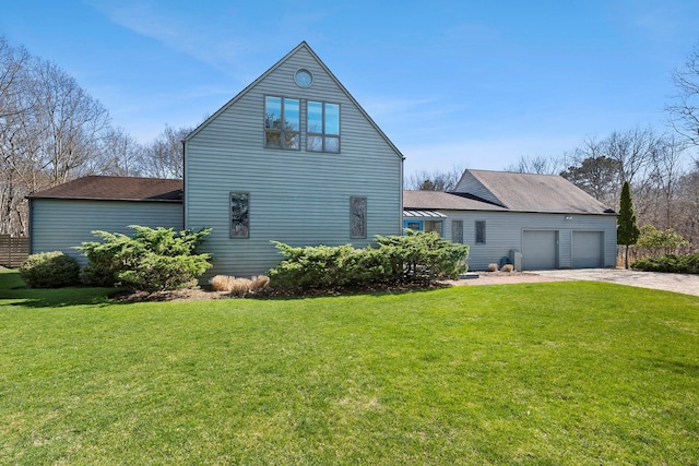 211 Red Dirt Rd, East Hampton, NY 11937 - view of side of property with a garage, a yard, driveway, and a shingled roof