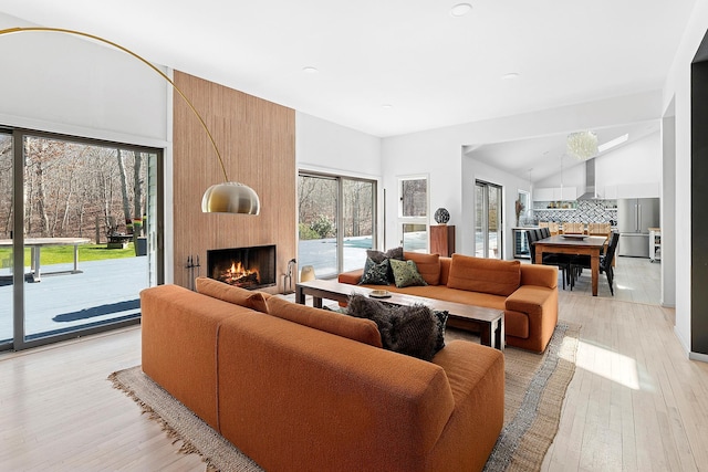 211 Red Dirt Rd, East Hampton, NY 11937 - living room featuring high vaulted ceiling, a large fireplace, light wood finished floors, and recessed lighting