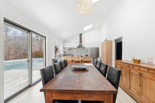 211 Red Dirt Rd, East Hampton, NY 11937 - dining area with a skylight, high vaulted ceiling, and light wood-type flooring