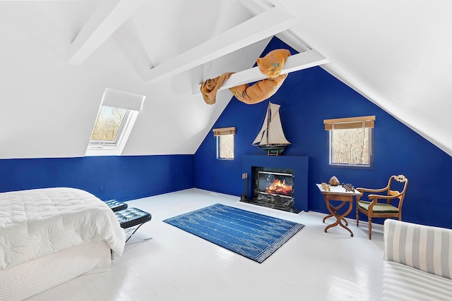 211 Red Dirt Rd, East Hampton, NY 11937 - bedroom with lofted ceiling with beams and a fireplace with flush hearth