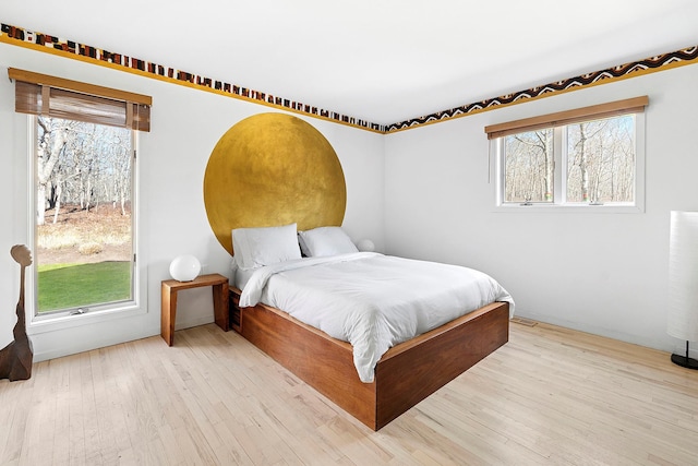 211 Red Dirt Rd, East Hampton, NY 11937 - bedroom featuring wood finished floors and multiple windows