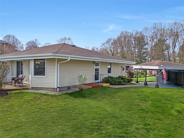 rear view of house with a lawn and a shingled roof