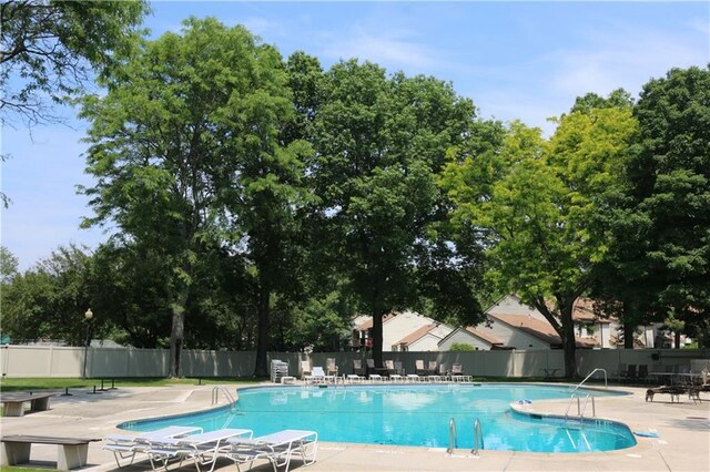 pool with fence and a patio area