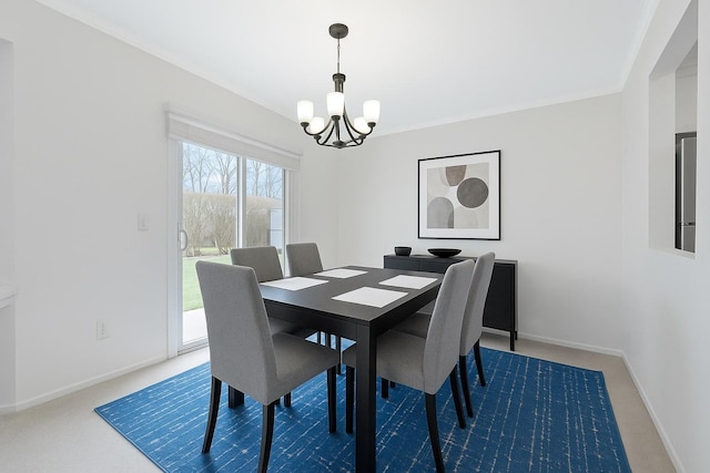 carpeted dining room featuring crown molding, baseboards, and a notable chandelier