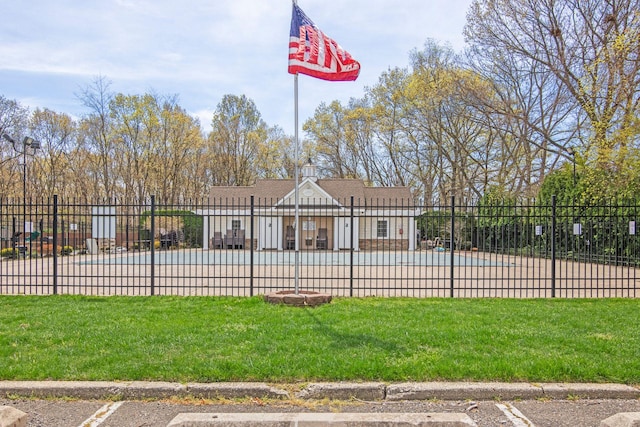 view of swimming pool featuring a yard and fence