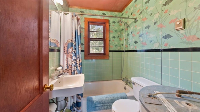 full bath with tile walls, wallpapered walls, shower / tub combo with curtain, and toilet