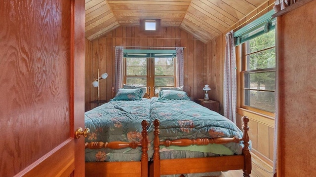 bedroom featuring wooden walls, vaulted ceiling, and wooden ceiling