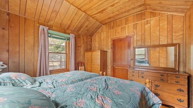 bedroom featuring vaulted ceiling, wood walls, and wooden ceiling