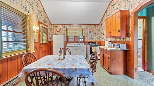 dining room featuring wallpapered walls, a wealth of natural light, and a baseboard radiator