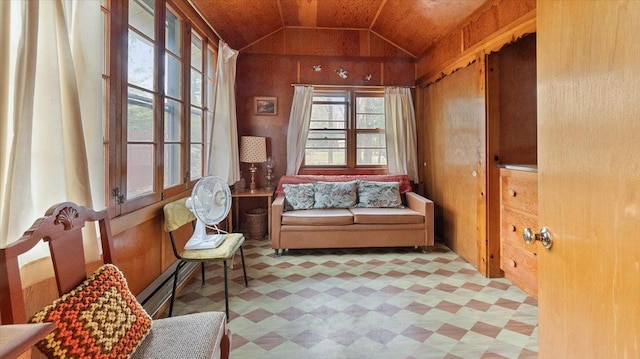 living area with lofted ceiling, tile patterned floors, and baseboard heating