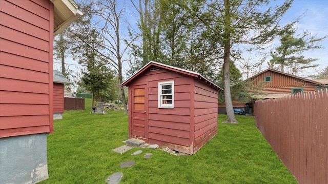 view of shed featuring fence
