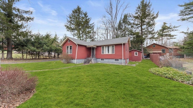 rear view of property featuring a lawn