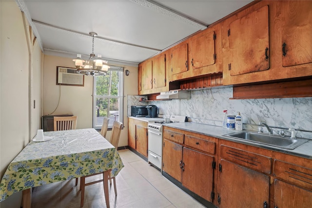kitchen featuring brown cabinetry, decorative backsplash, white gas range, a sink, and a notable chandelier