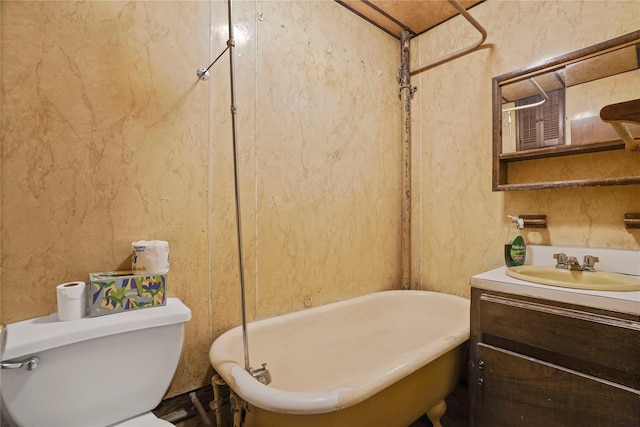 full bathroom featuring toilet, a soaking tub, and vanity