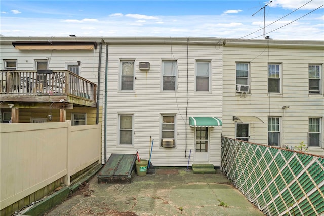 back of property featuring fence and cooling unit
