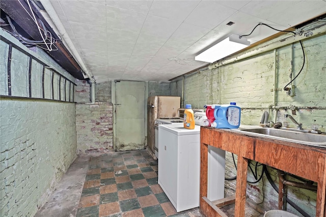 laundry room with laundry area, a sink, and dark floors