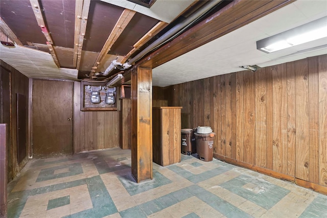 finished basement with tile patterned floors and wooden walls