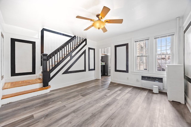 69-06 79th St, Middle Village, NY 11379 - unfurnished living room featuring stairs, wood finished floors, ceiling fan, and baseboards