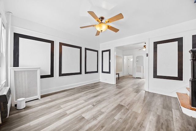 69-06 79th St, Middle Village, NY 11379 - unfurnished living room with ceiling fan, wood finished floors, and baseboards