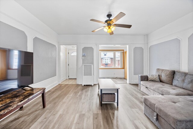 69-06 79th St, Middle Village, NY 11379 - living area featuring a ceiling fan, light wood-style floors, and baseboards