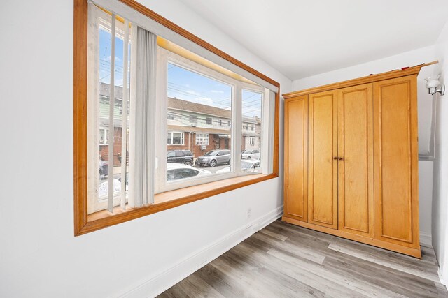 69-06 79th St, Middle Village, NY 11379 - unfurnished bedroom featuring wood finished floors and baseboards