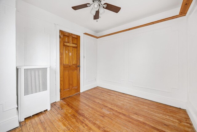 69-06 79th St, Middle Village, NY 11379 - empty room with ceiling fan and light wood-style flooring