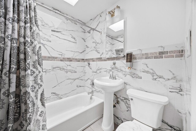 69-06 79th St, Middle Village, NY 11379 - full bath featuring tile walls, shower / bath combo with shower curtain, toilet, and wainscoting
