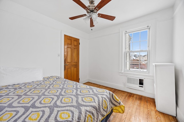 69-06 79th St, Middle Village, NY 11379 - bedroom with hardwood / wood-style flooring, baseboards, and a ceiling fan