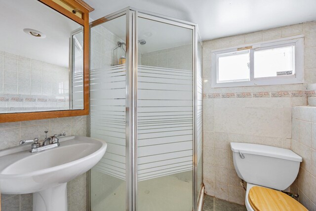 69-06 79th St, Middle Village, NY 11379 - full bathroom featuring tile walls, toilet, a shower stall, and a sink