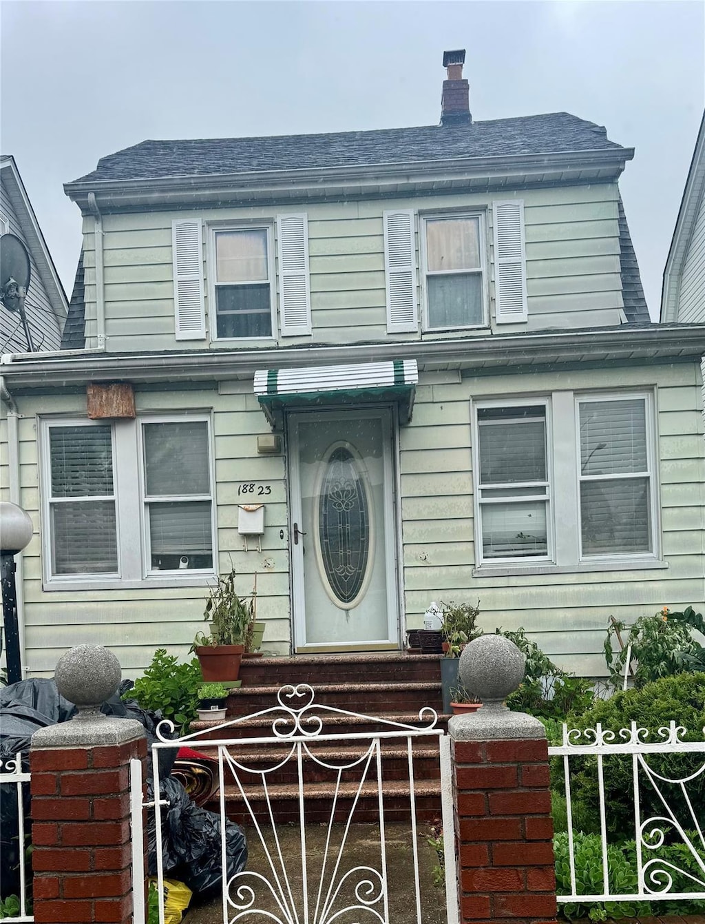 18823 Mangin Ave, Jamaica, NY 11412 - view of front facade with a chimney