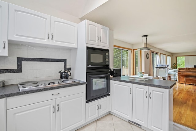 48 Sabbath Day Hill Rd, South Salem, NY 10590 - kitchen with black appliances, dark countertops, a peninsula, white cabinetry, and backsplash