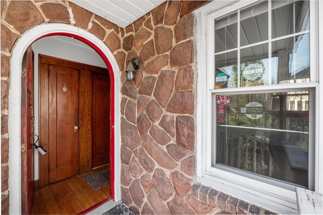 doorway to property featuring stone siding