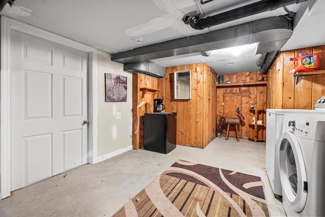 washroom with wood walls, laundry area, and washer / clothes dryer