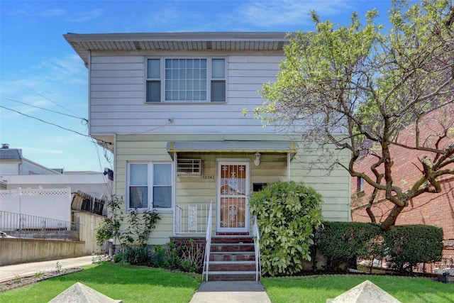 13042 NW 59th Ave, Flushing, NY 11355 - view of front facade featuring fence and a front yard