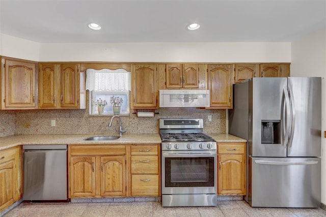 13042 NW 59th Ave, Flushing, NY 11355 - kitchen featuring brown cabinets, a sink, light countertops, stainless steel appliances, and decorative backsplash