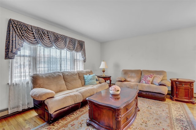 13042 NW 59th Ave, Flushing, NY 11355 - living area featuring light wood finished floors and a baseboard heating unit