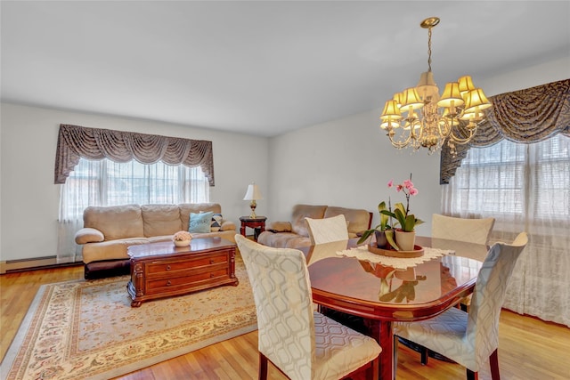 13042 NW 59th Ave, Flushing, NY 11355 - dining space with a baseboard heating unit, a notable chandelier, and light wood finished floors