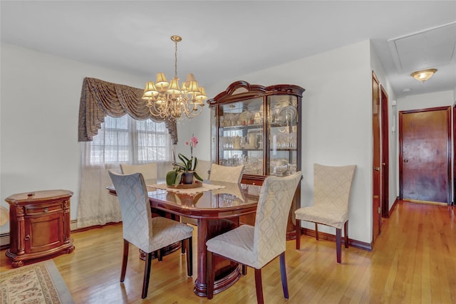 13042 NW 59th Ave, Flushing, NY 11355 - dining area with an inviting chandelier, attic access, and hardwood / wood-style flooring