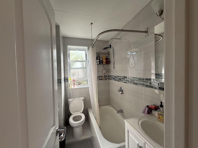 bathroom with vanity, shower / tub combo with curtain, toilet, and tile walls