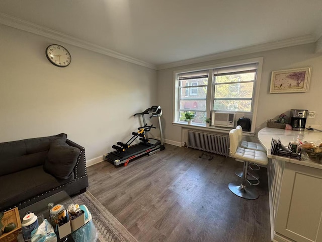 interior space featuring crown molding, wood finished floors, baseboards, cooling unit, and radiator heating unit