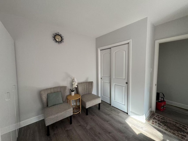 sitting room featuring baseboards and wood finished floors