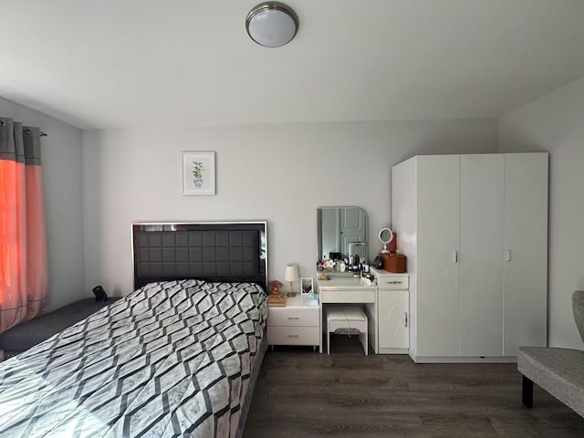 bedroom with dark wood-style floors