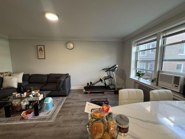 living room featuring crown molding, baseboards, wood finished floors, and cooling unit