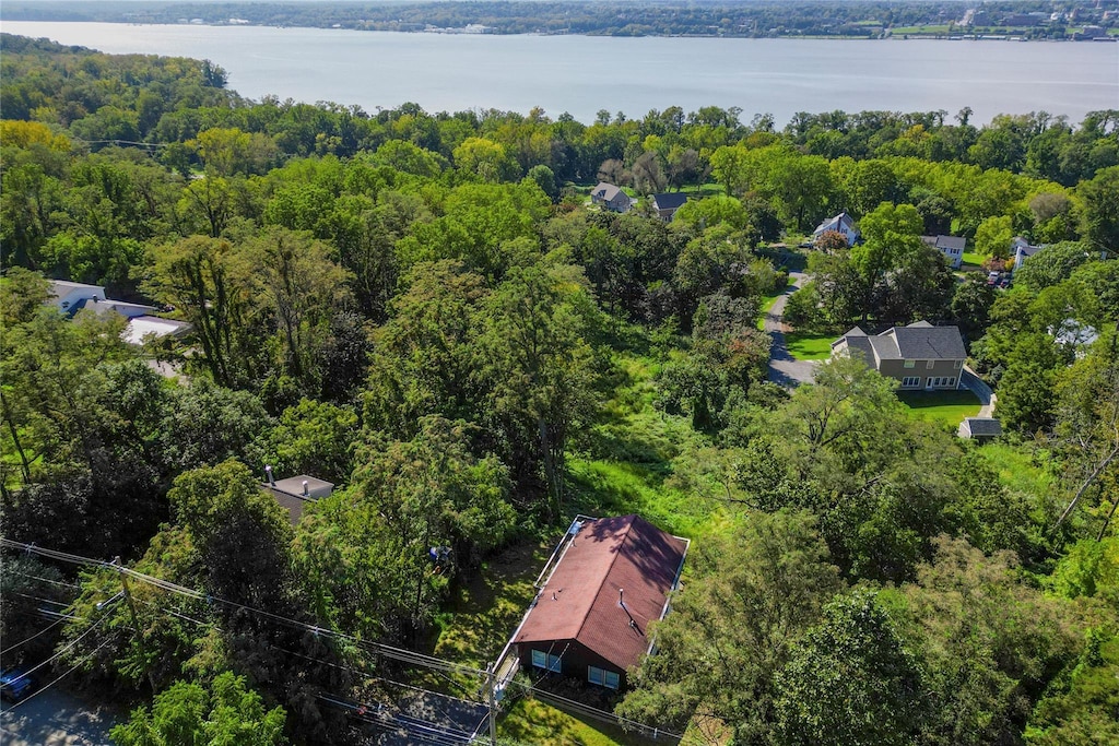 bird's eye view featuring a wooded view and a water view
